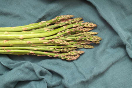 Green asparagus on green clothの写真素材