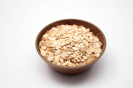 Oat flakes in a wooden bowl.の写真素材