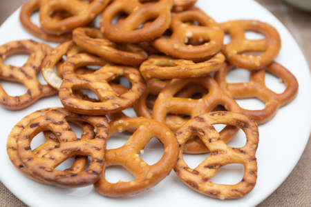 Salted crispy pretzels on white plate