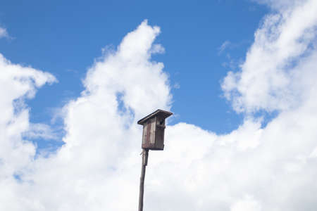 Wooden birdhouse against the sky.の写真素材