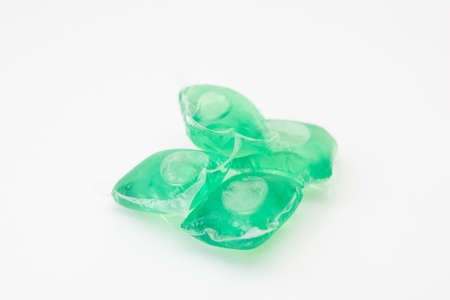 Green washing gel capsule on white background.