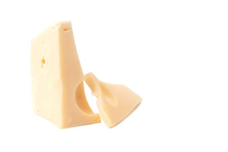 Pieces of cheese with holes on a white backgroundの写真素材