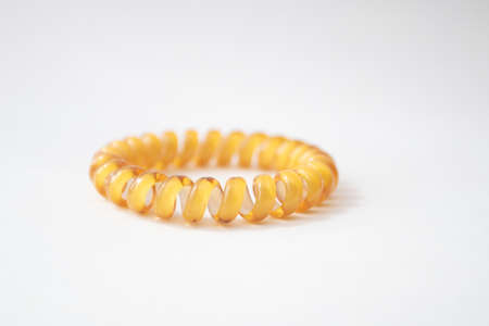 Yellow Rubber spiral Hair Band on white background.