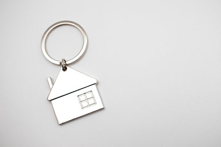 Metal keychain in the shape of a house.の写真素材