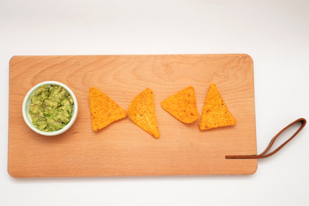 Nachos and guacamole on wooden boardの写真素材