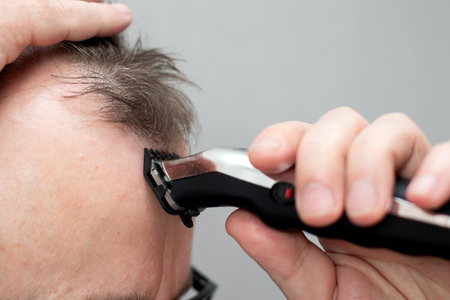 Man cut hair with cutting shaving machineの写真素材