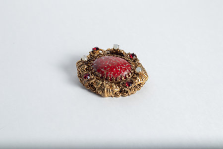 Antique brooch on a white background.