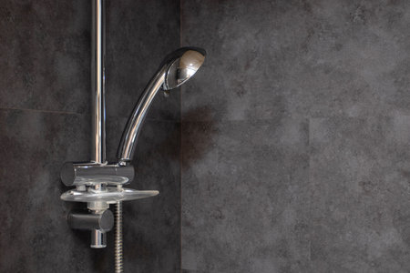shower in the bathroom. Interior in the bathroom. Loft modern bathroom with black and gray tiles.の写真素材