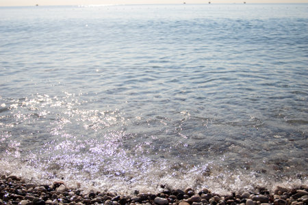 seashore splashes of water and pebbles.の写真素材