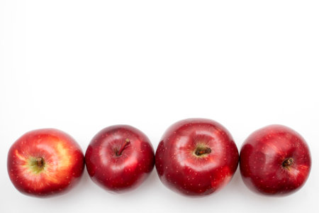 Row of Red apples on a white background.の写真素材