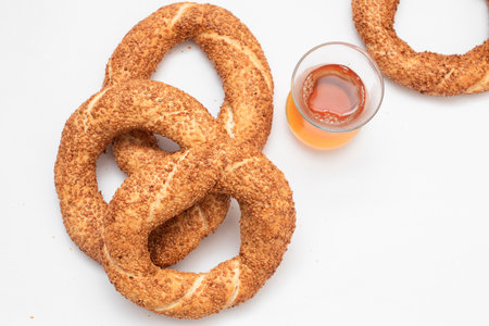 Turkish bagel simit and tea on white background