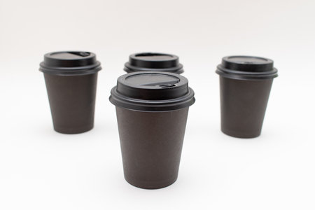 Disposable black plastic cups on a white backgroundの写真素材