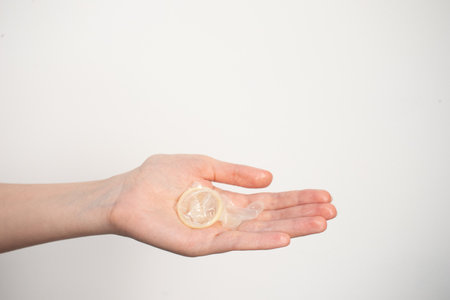 Used condom on hand. contraception.の写真素材