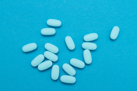 Blue pills for potency on blue backgroundの写真素材