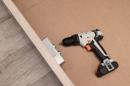 Assembling a new furniture using a screwdriverの写真素材
