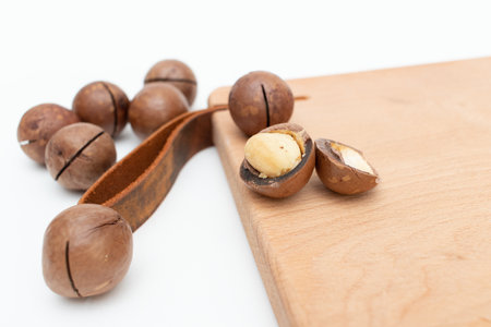 Macadamia nuts on wooden board.の写真素材