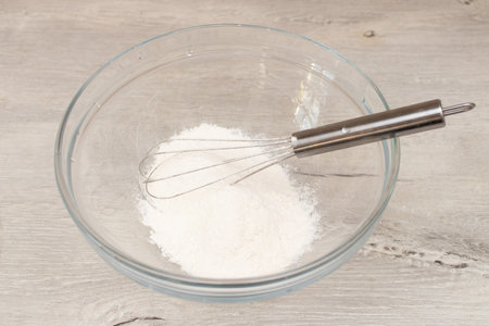 Dough for home pancakes. Mix flour and eggs in a bowl.の写真素材