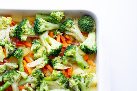 healthy food in a baking dish. Broccoli, carrots and potatoes preparation for bakingの写真素材