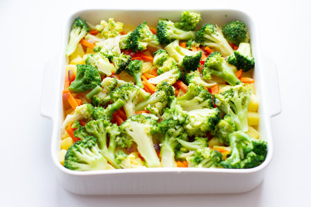 Broccoli, carrots and potatoes in a baking dish.の写真素材