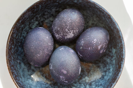 Dyed blue and marble easter eggs in bowlの写真素材