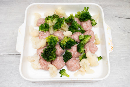 Meat balls and broccoli in a baking dish?の写真素材