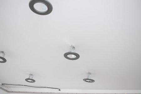 Installation of LED lamps on a stretch ceiling.の写真素材