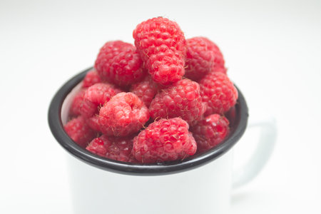 Fresh raspberry berry in a mug.の写真素材