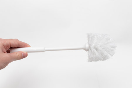 White toilet brush in hand.の写真素材