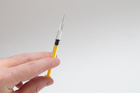 thin syringes for insulin injection on hand on white background.の写真素材