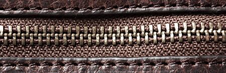 Detail of a zipper on brown leatherの写真素材