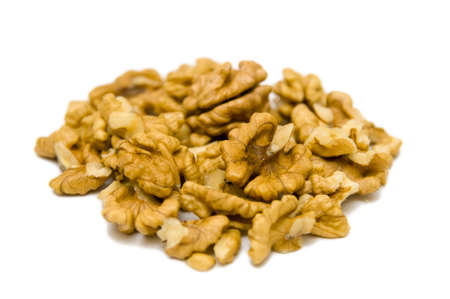 Shelled walnuts close up isolated on white background.