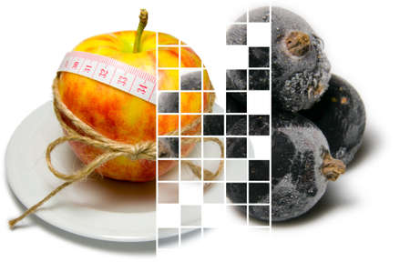 Collage of apple surrounding of measuring tape tied with twine and frozen black currants closeup on different layers separated by mixing layers transparent squaresの写真素材