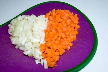 Carrot and onion diced closeup in the shape of heartの写真素材