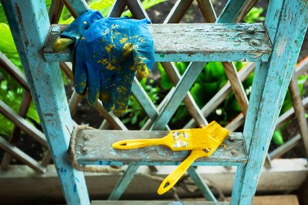 brush and oil paint on wood ladderの写真素材