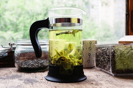 tea in the French press on the table