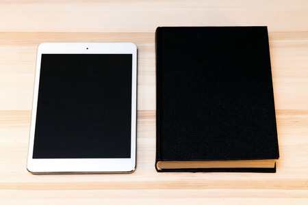 book and digital tablet on the table