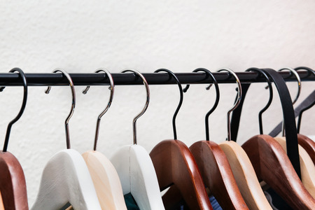Clothes hang on a shelf in home