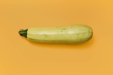 Fresh ripe vegetable marrow on yellow backgroundの写真素材