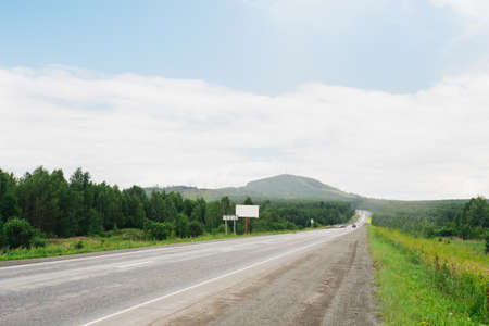Road on a sunny day, around the forestの写真素材