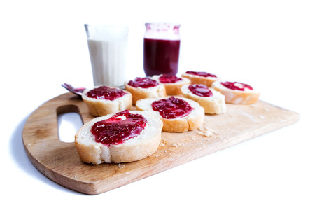 Breakfast with baguette, butter, jam and milkの写真素材