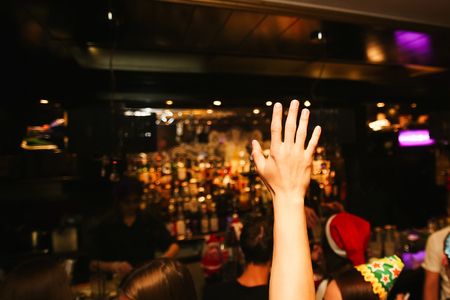 Man hand making sign. On bar backgroundの写真素材