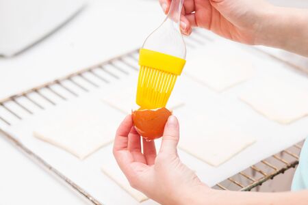 Smearing egg pie. Cooking sweet pastries. Handsの写真素材