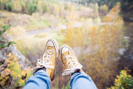 woman hiker legs on mountain peak rockの写真素材