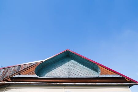 sharp roof top of wooden house. blue skyの写真素材