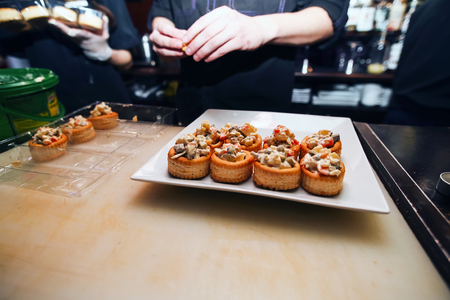 Preparation of salad in rolls. Chef at the barの写真素材