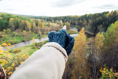 Woman hiker pointing far away in the nature