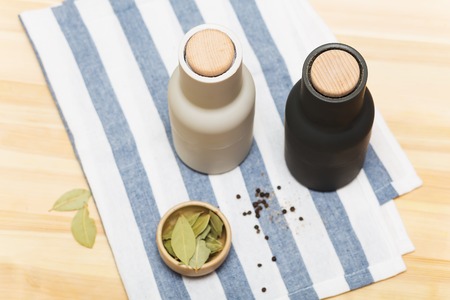 wooden pepper mills on the table backgroundの写真素材