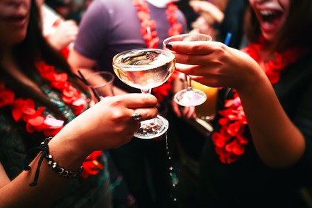 Clinking glasses with alcohol and toasting, party. Congratulations to the event. Cheerful party friendsの写真素材