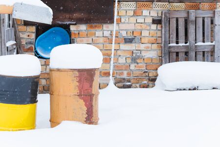 House drain pipe and rusted rusty barrel. Winterの写真素材