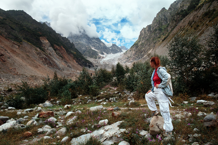 A woman traveling in the mountains, going ahead to the heights.の写真素材